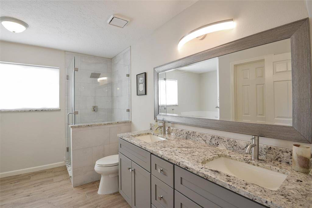 Primary En-Suite Bathroom with Dual Vanity, Walk-In Shower.