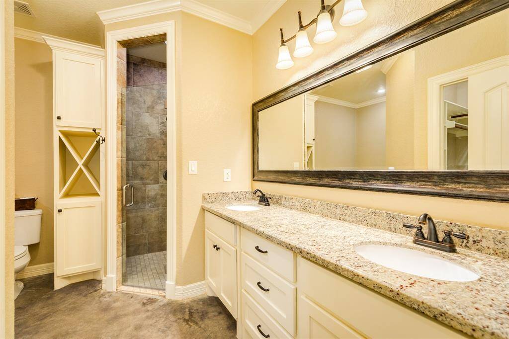 Primary ensuite with double vanity a spa like walk in shower.