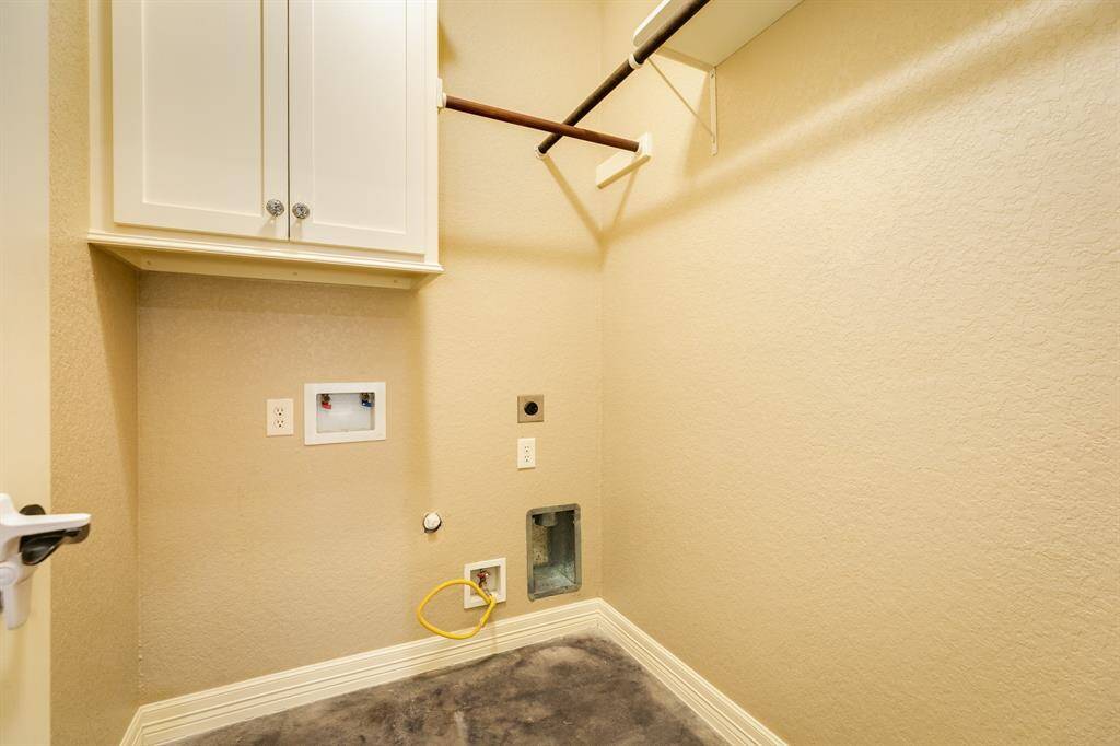 Indoor utility with storage and hanging racks for convenience.