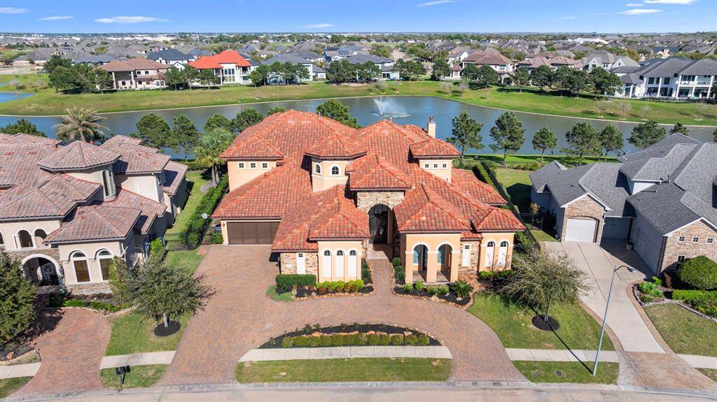 An opulent Mediterranean estate for the discerning buyer. This custom home is reminiscent of old-world elegance & is positioned on a premier waterfront lot in the gated enclave of Lago Verde Estates.