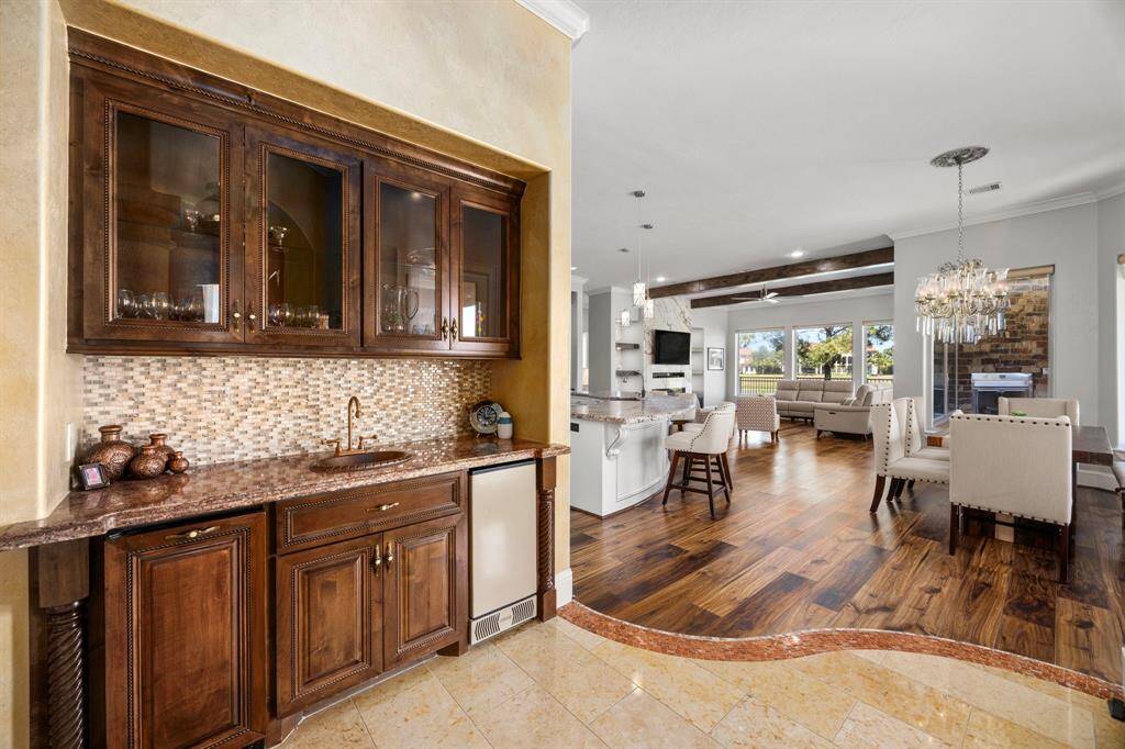 A cocktail bar in the dining room cultivates a refined atmosphere for dinner parties & is essential for entertaining.