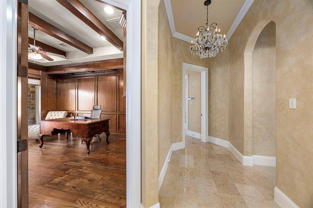 A vestibule entry transitions to the private areas of the library, primary suite and second bedroom suite.