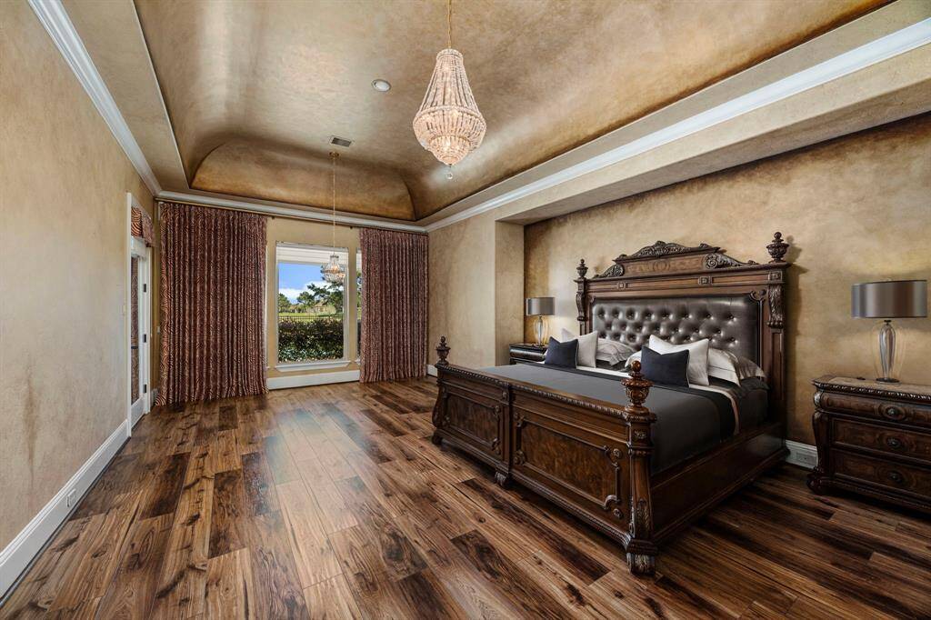 Designed to envelope you in luxury from the moment you enter. The primary suite offers illustrious walls, coved barrel ceiling & a warm ambience that creates a beautiful retreat. Step outside to a private loggia overlooking the pool with serene lake views.