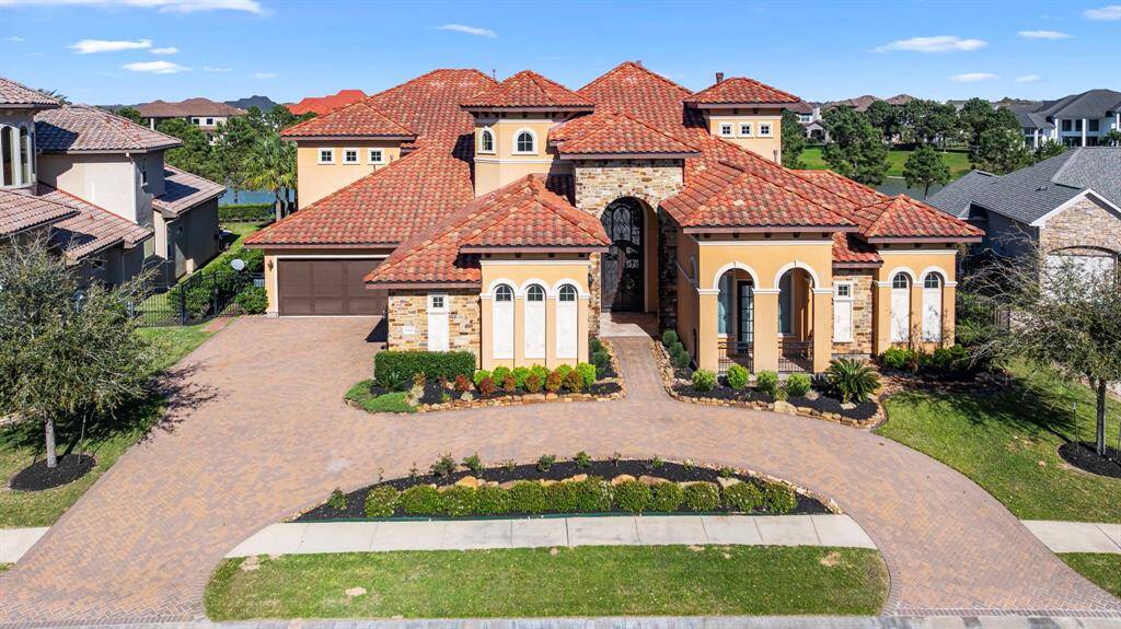A home that beckons you to indulge in a luxurious lifestyle where architectural grandeur & exceptional attention to detail abounds. The tiled roof adds timelessness to the stone & stucco elevation.