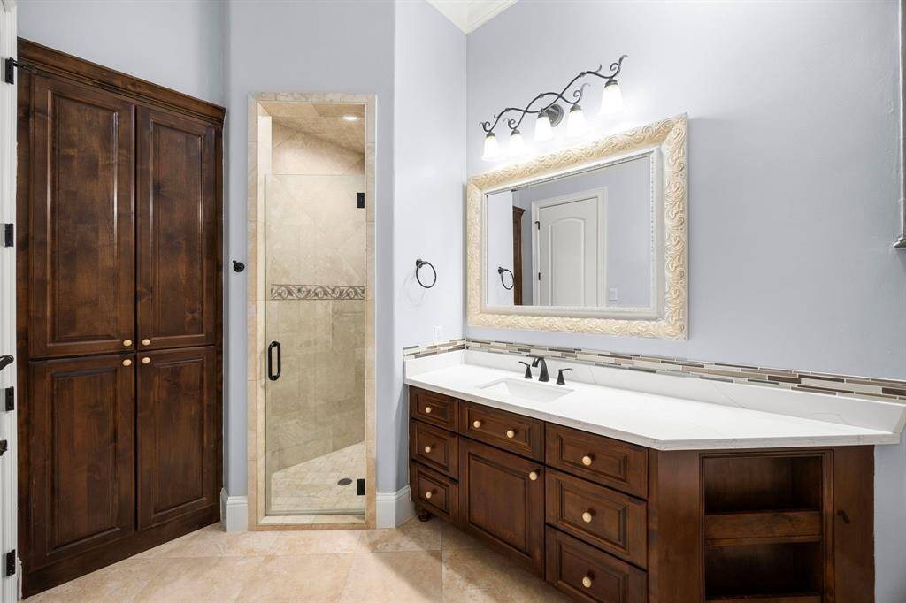 En-suite bath 2 is thoughtfully designed with clean lines, custom cabinetry, high-end finishes, luxury details & recent improvements.
