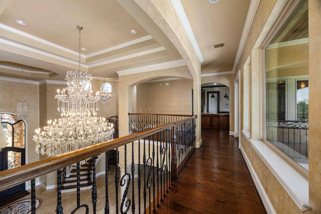 Hardwood flooring spans the upstairs landings & pours into the game room.
