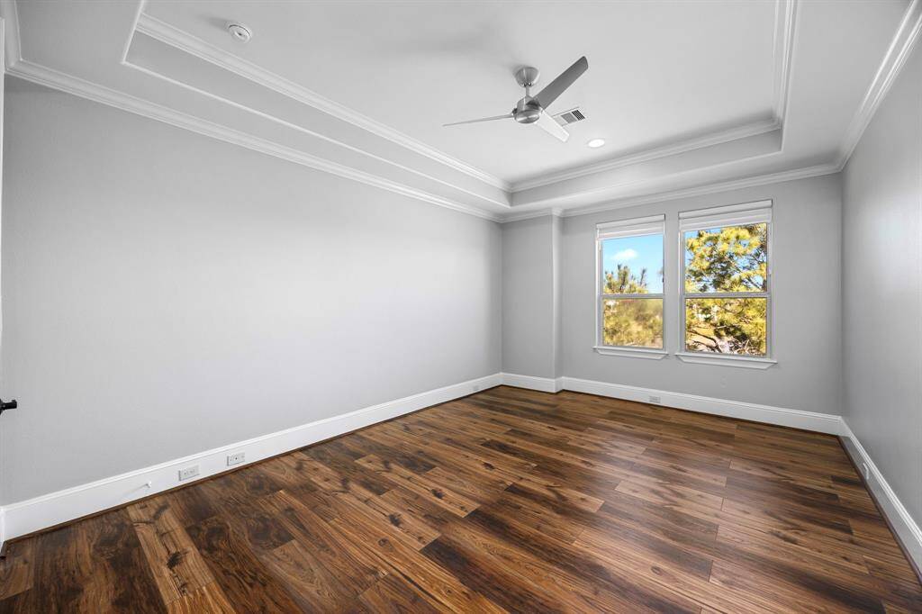Bedroom Suite 5 is located upstairs just off the game room & features beautiful lake views, tray ceilings, luxury flooring & a Minka fan.