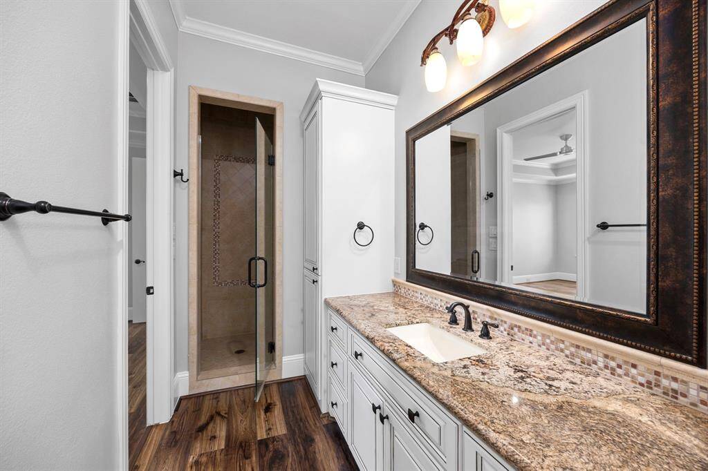 En-suite bath 5 is thoughtfully designed with custom cabinetry, recent improvements & a luxury walk-in closet that offers built-in amenities.