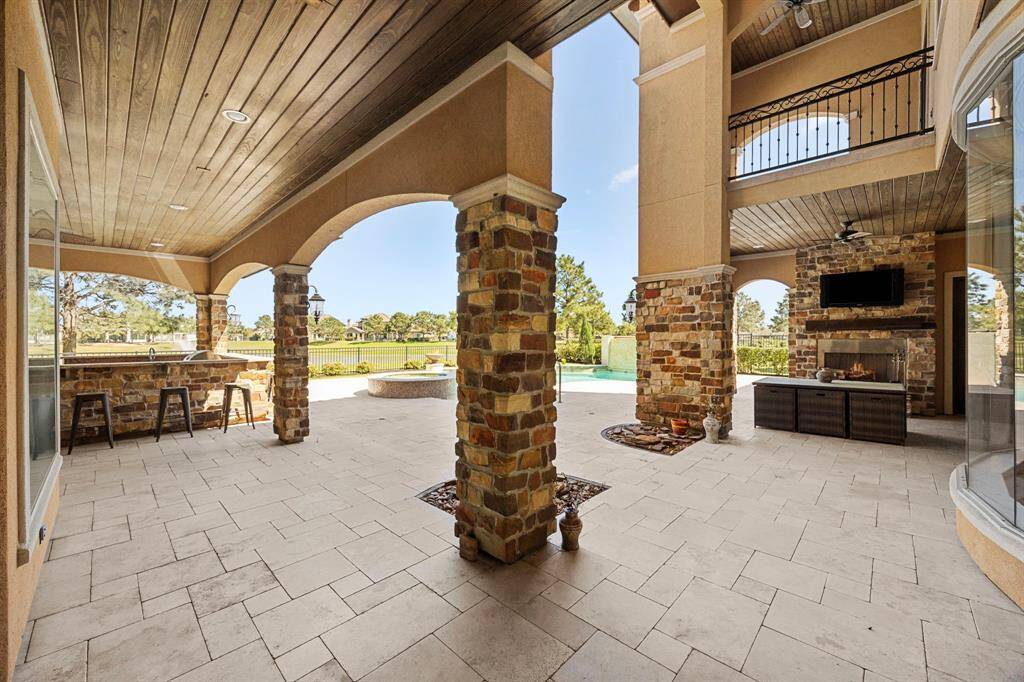 Arched loggias beautifully surround the lagoon-style pool & offer a serene outdoor retreat that blends indoor-outdoor living seamlessly. Spaces for intimate gatherings by the fireplace or sunset dinner parties al fresco.