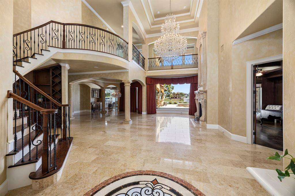 A palatial home that welcomes you with a grand sweeping staircase & rooms bathed in natural light from windows that offer perfect views of the lake. This home is designed for entertaining & flows effortlessly between the formal & informal areas.