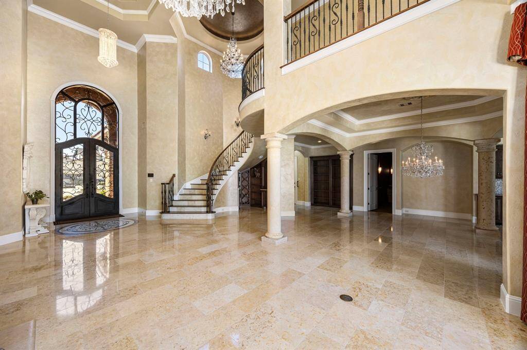 Stunning chandeliers suspended above offer ambient lighting & exude European elegance. Natural stone floors seamlessly pour through the space enhancing the opulence.