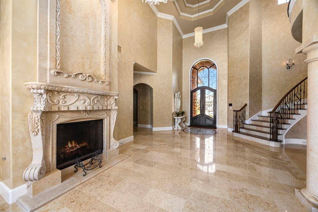 The grandeur of this exquisite carved stone fireplace is reminiscent of an Italian villa.