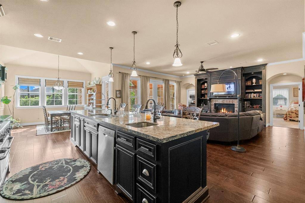 Kitchen opens to breakfast area and family room with arched entrances to guest suite.