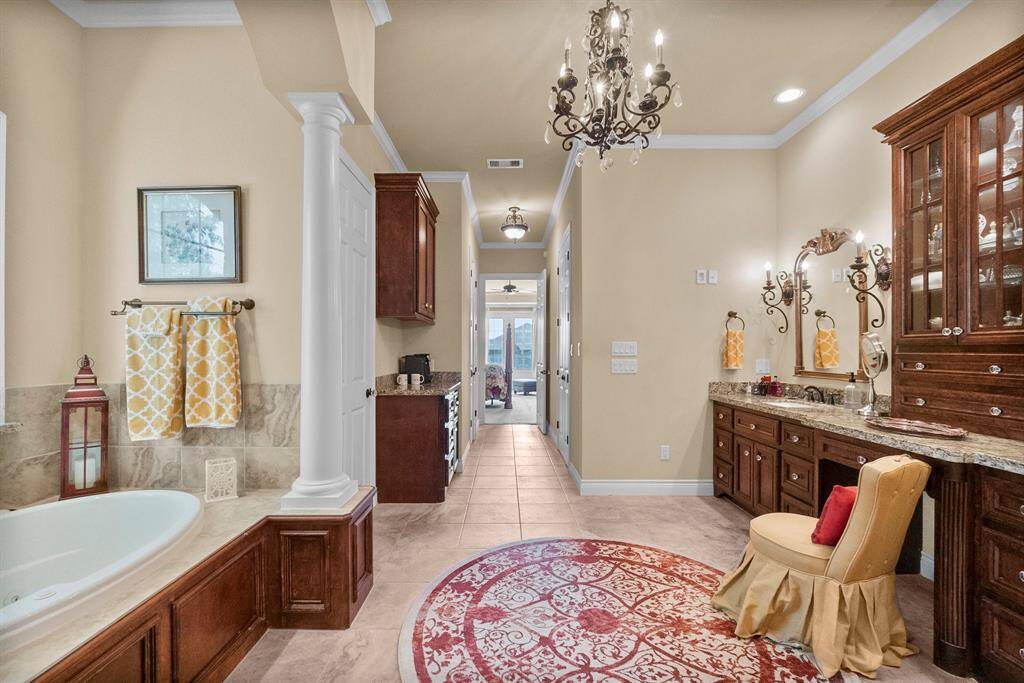 Primary bath features two walk-in closets and beautiful details.