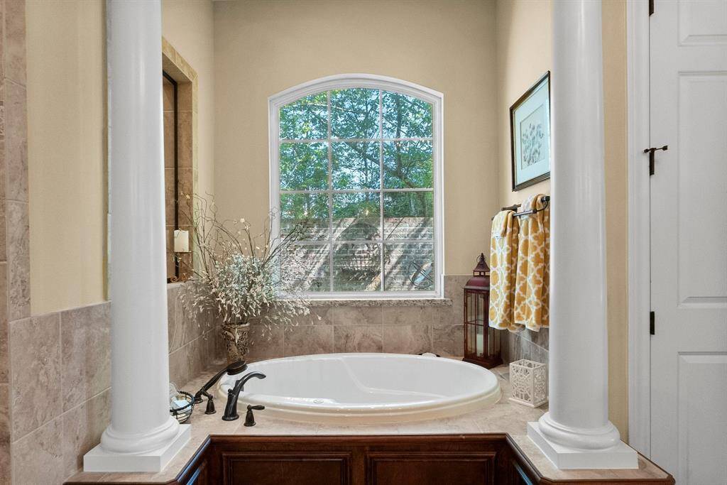 Primary bathtub with window to private courtyard.