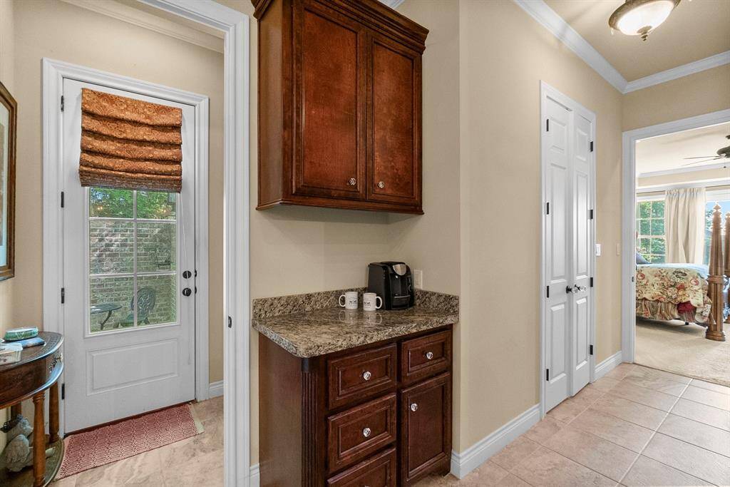 Coffee station in primary bath with door to private courtyard.