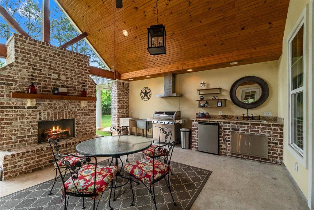 Outdoor kitchen with sink, under counter refrigerator, storage and chopping block.
