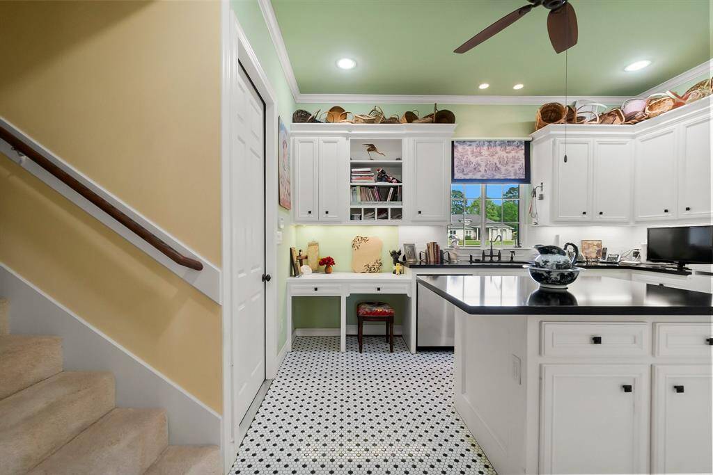 Utility/butler pantry with stairs to bonus and game rooms upstairs.