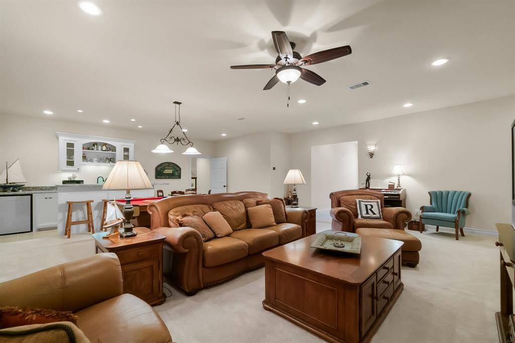 Spacious game room upstairs has closets and access to attic storage.