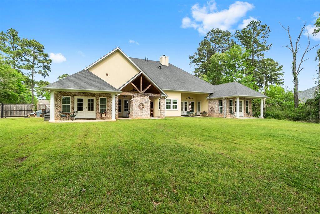 Back of home with French doors to 4 distinct patios.