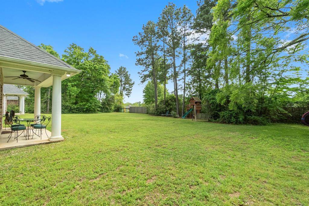 Backyard with gate to Grand Harbor pond and green space.