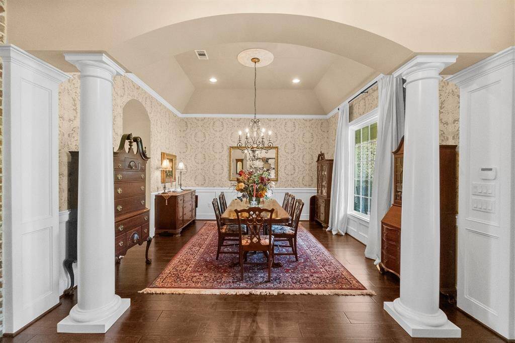 Formal dining with custom wainscoting and columns.
