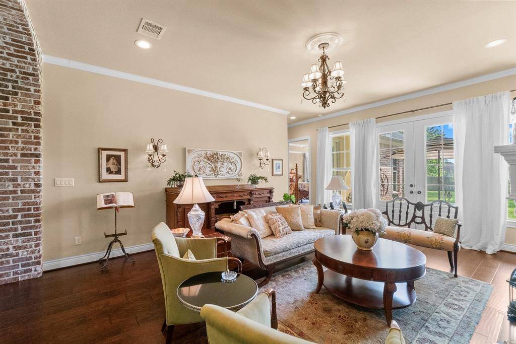 Brick archway from foyer to formal living room with French doors to patio.