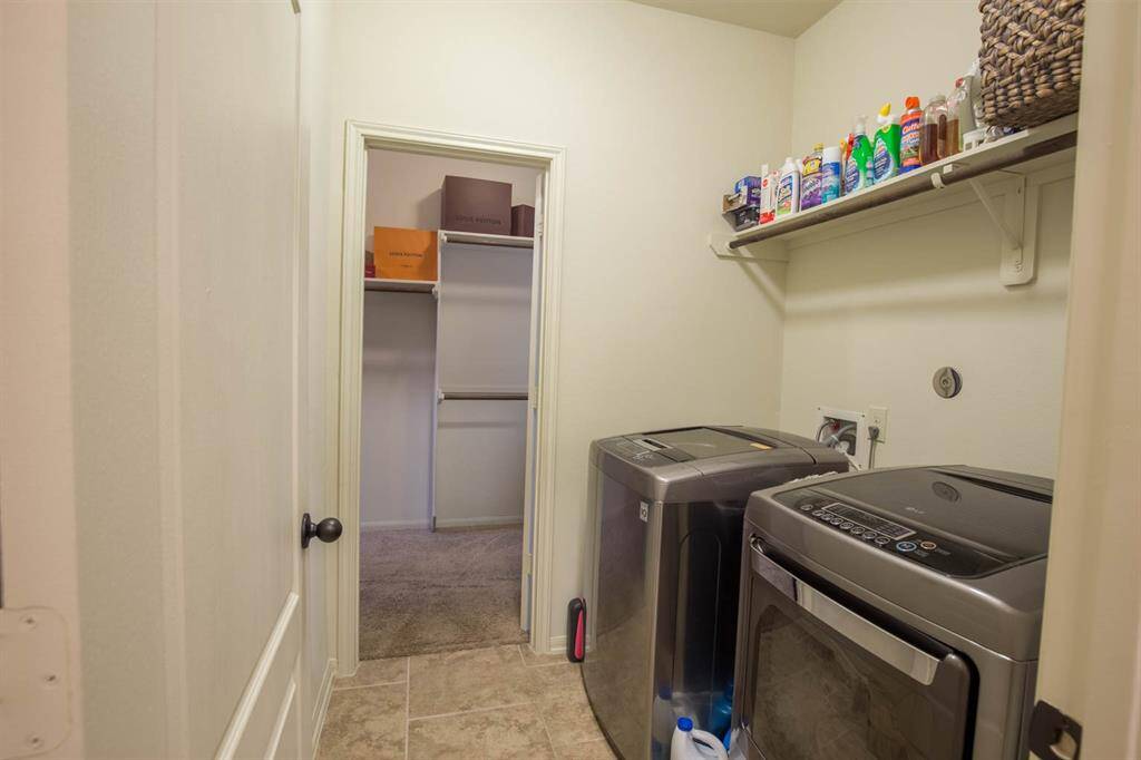 Large Utility room opens up to primary closet