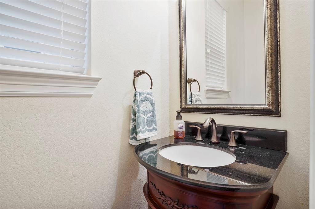 This half bath downstairs is located to the left of the kitchen across from the walk in pantry.