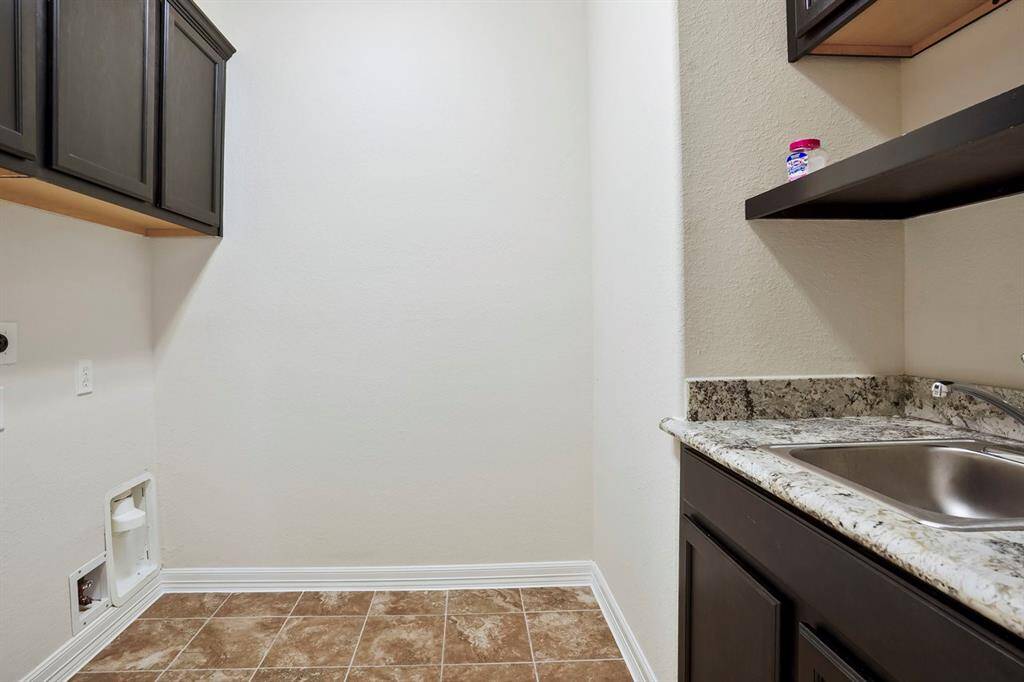 Large primary bathroom with separate vanity areas, separate jetted tub and walk in shower.  Also features separate walk in closets.