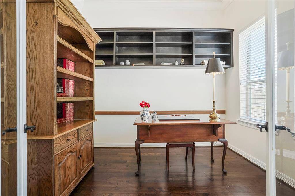 Large office with shelving on back wall.