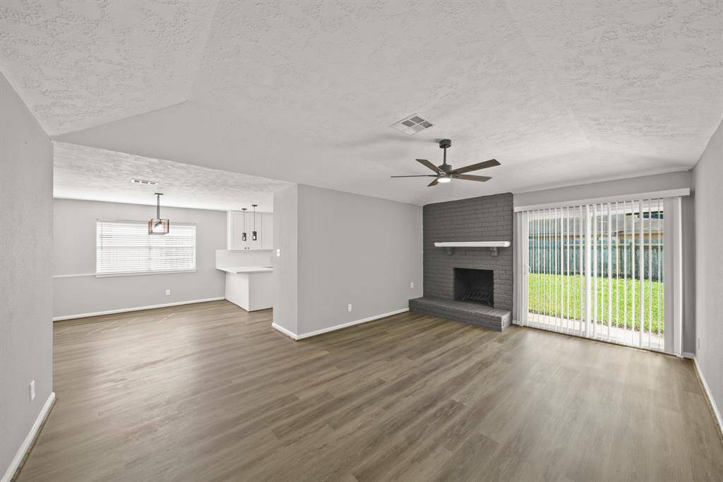 Entry towards living and kitchen featuring new LVP flooring throughout