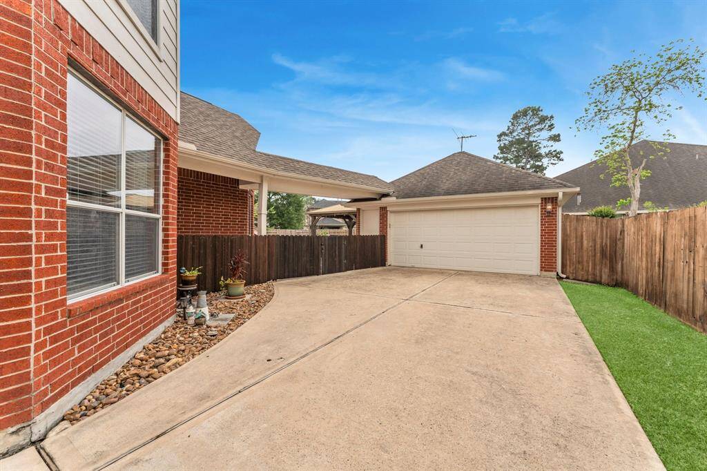 2 car garage is oversized with storage space on the side and back