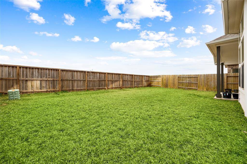 Expansive, fully fenced backyard offering a private setting and endless outdoor possibilities.