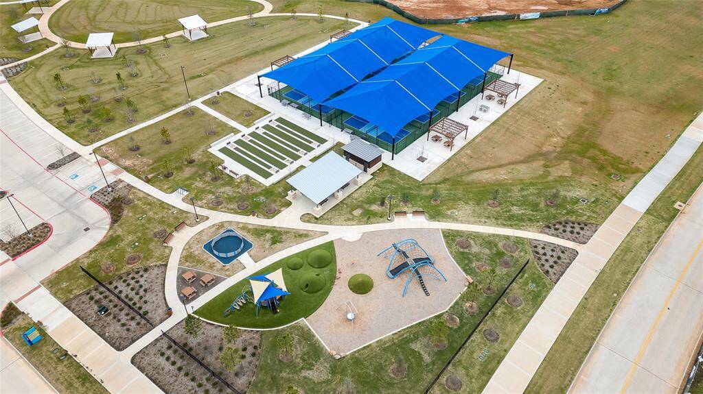 A closer overhead look at the brand-new recreational complex, featuring shaded gathering spaces, a playground, and plenty of open green areas.