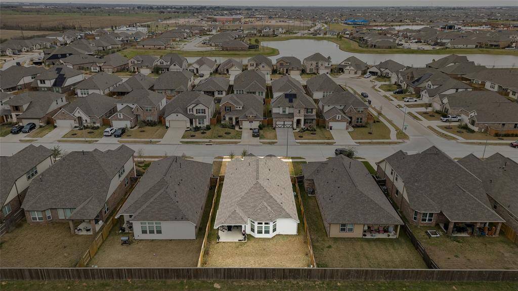 A wide aerial view of the neighborhood highlighting the future lagoon-style pool (slated for completion this summer) and surrounding residential community.