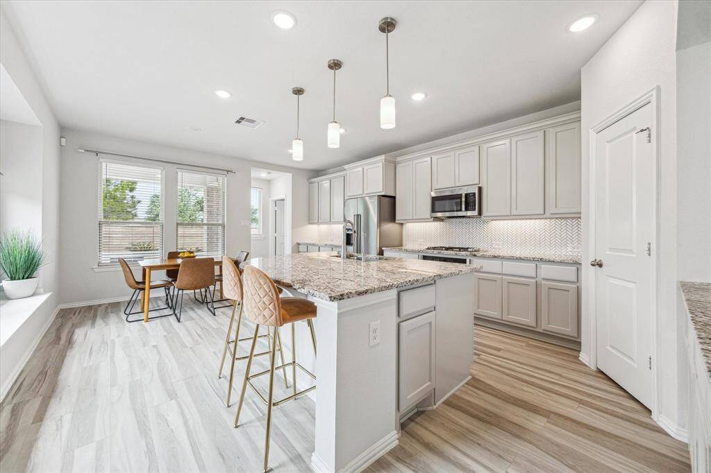 The open floor plan joins the dinning area, kitchen and living room seamlessly with incredible natural light.