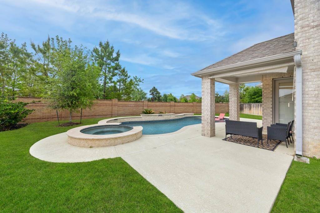 The crown jewel of this house is the magnificent outdoor living space featuring a custom pool and spa with a raised wall and spectacular water features for a full day of fun  in the sun - Accompanied, of course by the covered patio with extended sunny seating space in your private fenced backyard with lots of grassy area left over to enjoy a lawn game or playing fetch with your pet!