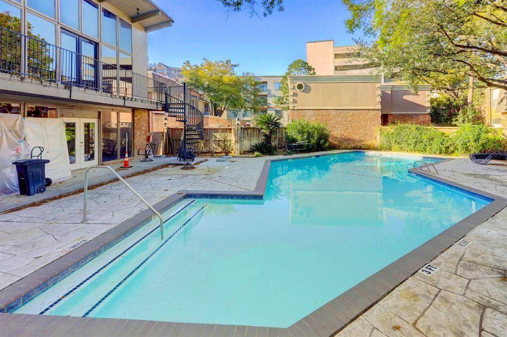 Refreshing large community pool with clubhouse