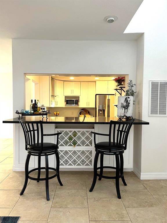 Huge granite bar with built-in wine storage
