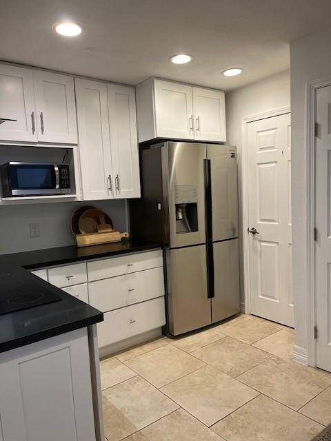 Another view of the kitchen that leads to a large laundry room