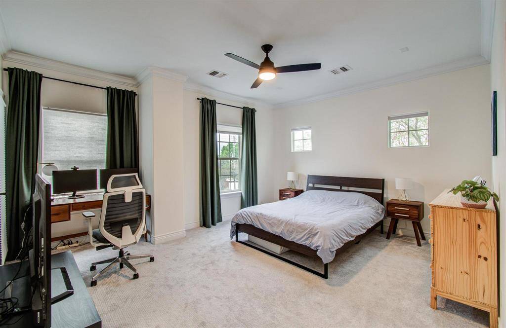 The spacious primary bedroom offers a serene retreat with direct access to a private balcony—perfect for morning coffee or evening unwinding.