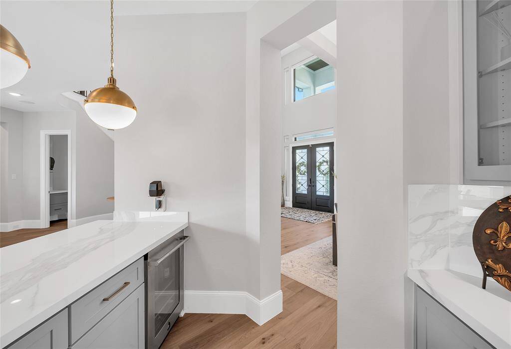Butler's pantry with mini fridge and custom built cabinetry.