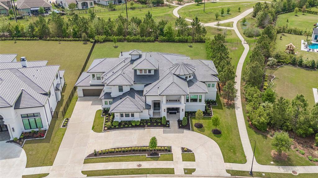 Full aerial view of the home and property, with no back neighbors, on an over half-acre lot.