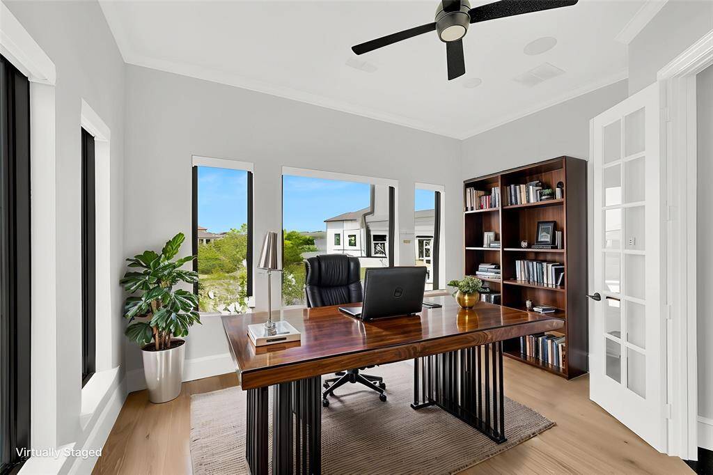 Virtually staged mid-level study with large windows and French doors.