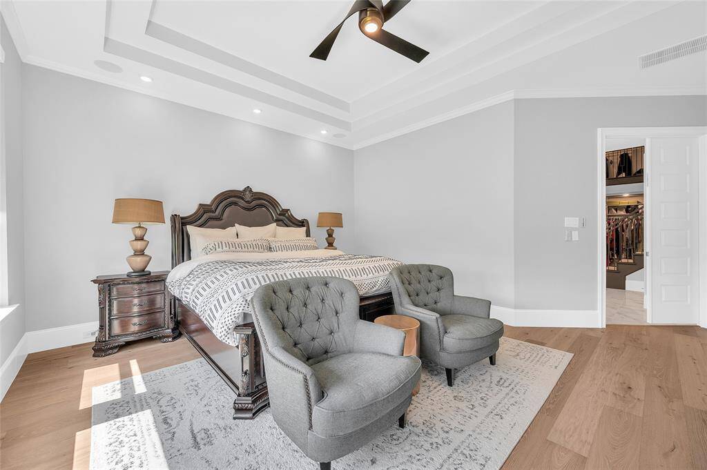 Spacious primary with tall ceilings and ample space for a sitting area.