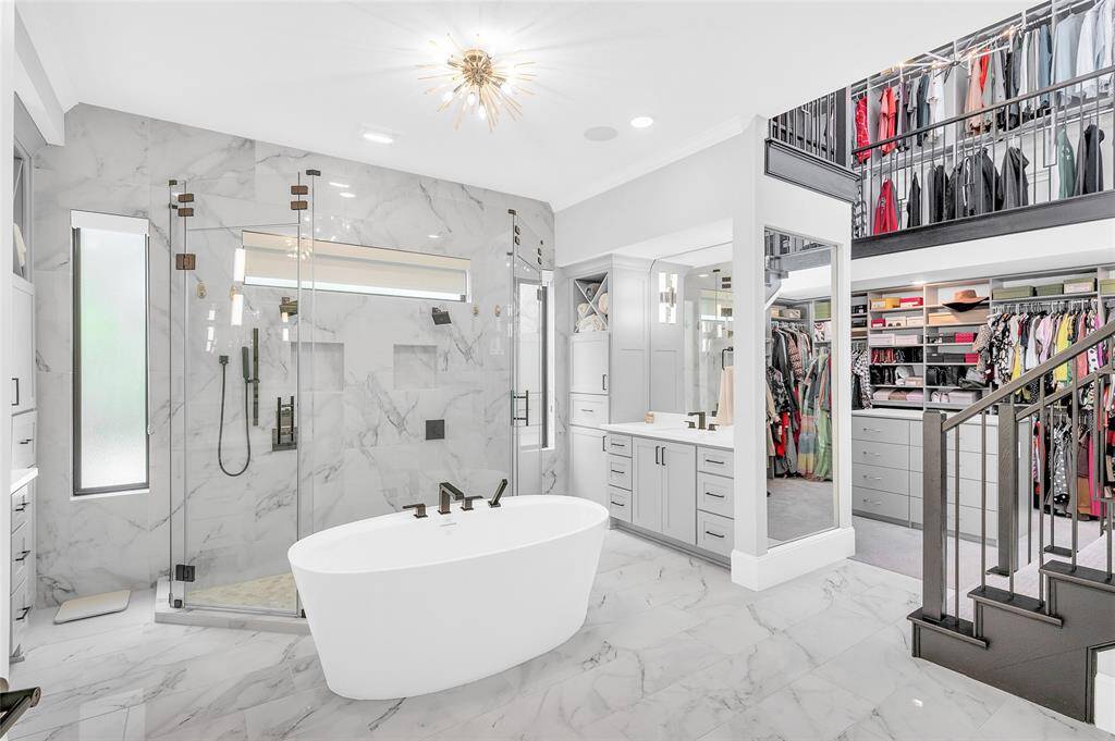 Expansive soaker tub and a lavish oversized walk-in shower with dual access, offering a spa-like retreat.