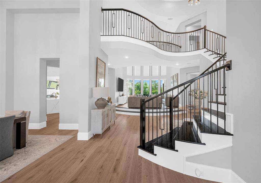 Grand foyer with views of the formal dining room and elevated living room.