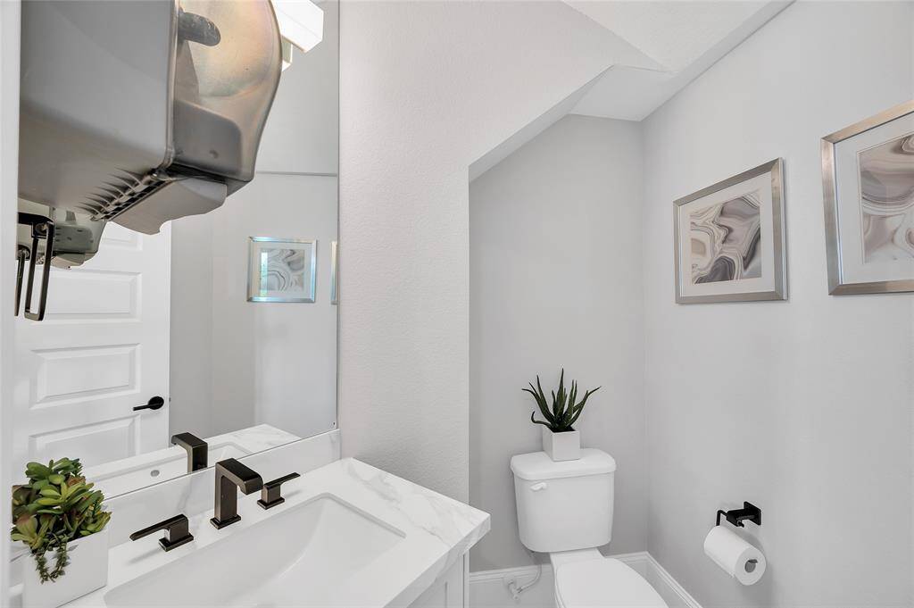 Half bath off the foyer and elevated sitting room.