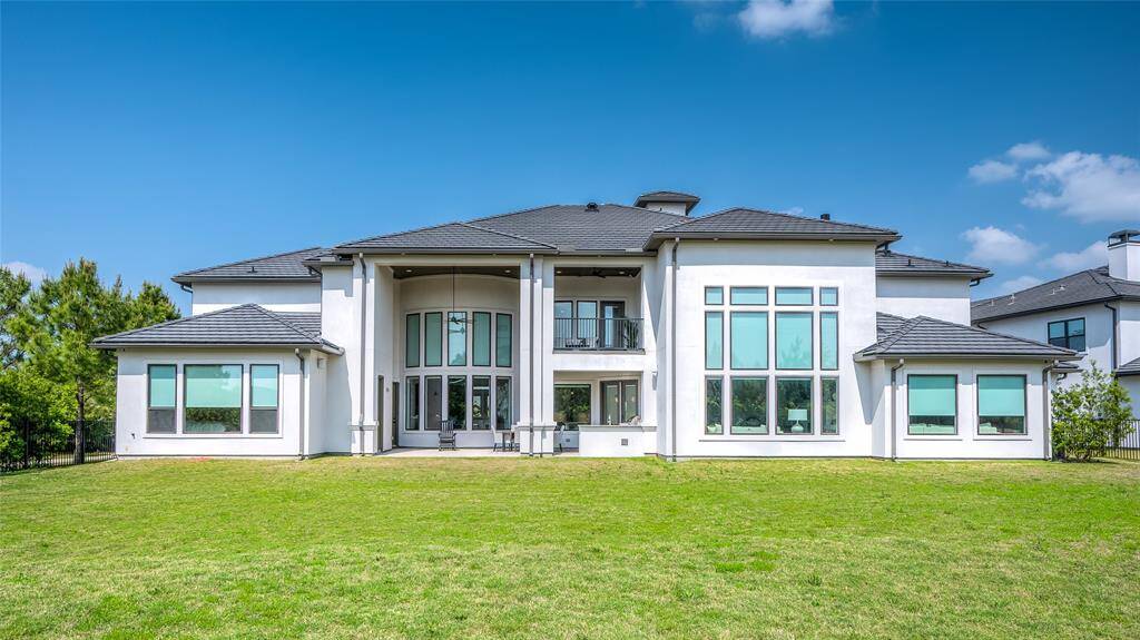 An expansive rear view of the home, where the meticulously designed windows enhance the architectural beauty.